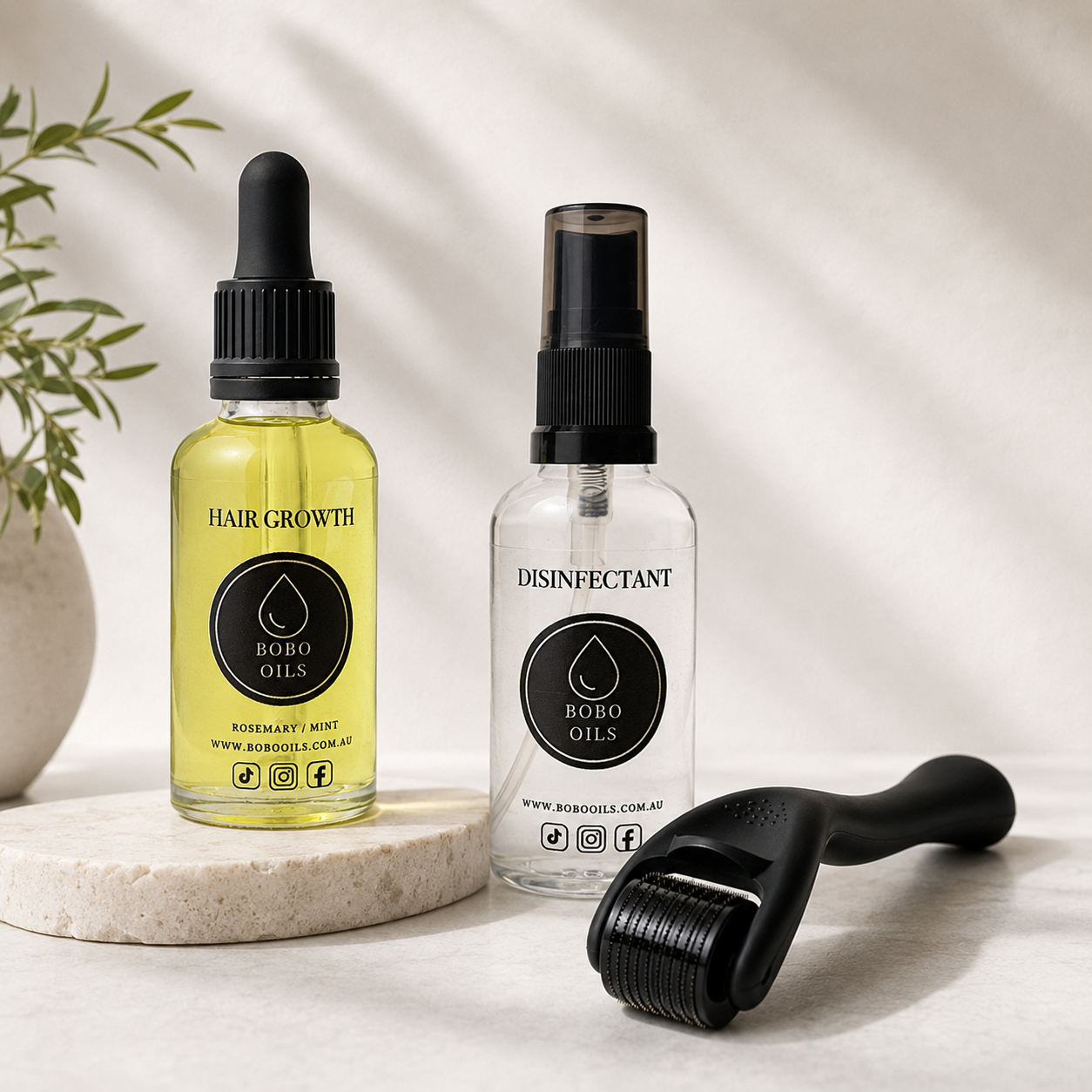 BOBO OILS Rosemary and Mint Hair Growth Oil bottle and BOBO OILS Scalp Derma Roller and Disinfectant Spray