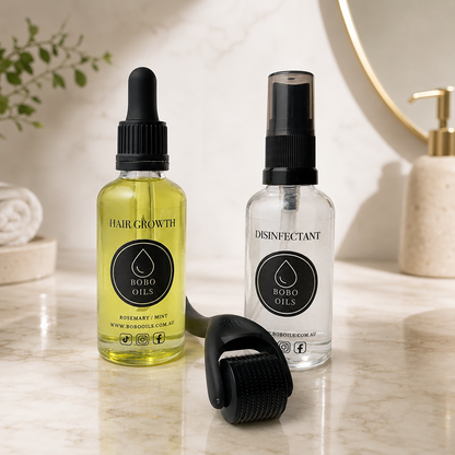 BOBO OILS Rosemary and Mint Hair Growth Oil bottle and BOBO OILS Scalp Derma Roller and Disinfectant Spray